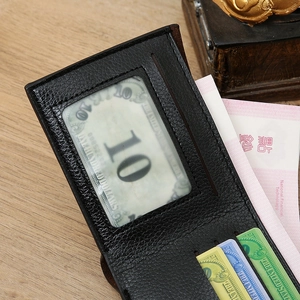 Close-up of black litchi grain leather wallet interior showing card slots and ID window