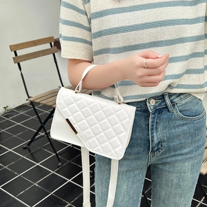 Stylish white quilted crossbody bag with embroidered strap and triangle flap detail.