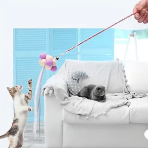 Interactive cat teaser wand with plush balls, feathers, and bells for playful kittens
