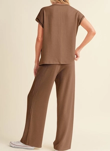 Detail of brown two-piece set showing ribbed knit texture and back of short sleeve top