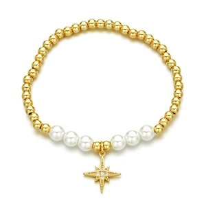 Golden beaded bracelet with pearls and zircon star pendant on white background