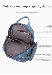 Internal view of blue denim backpack showing multi-pocket layout and silver metal zippers