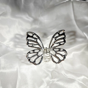Detailed view of an elegant hollow silver alloy butterfly hair claw with metallic finish