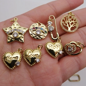 Selection of gold micro-pave zircon pendants with Mama, Love, and MOM engravings