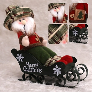 Christmas Santa Claus sitting in a black Merry Christmas sleigh decorative ornament