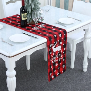 Christmas buffalo plaid table runner with elk and snowflake patterns for holiday dining