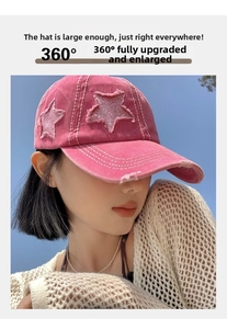 Close-up of pink distressed baseball cap with star patch and vintage frayed edge detail