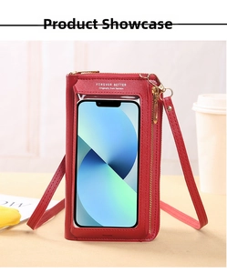 Detail of red leather crossbody phone bag featuring transparent touchscreen window and strap