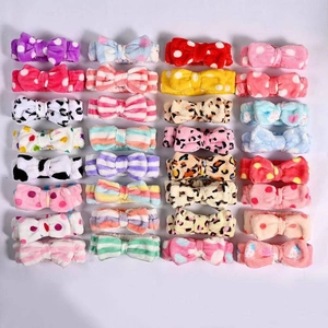 Macro view of plush coral fleece headband set with various polka dot and animal patterns