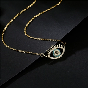 Elegante collana dorata con pendente occhio greco in zirconia blu e bianca su sfondo nero