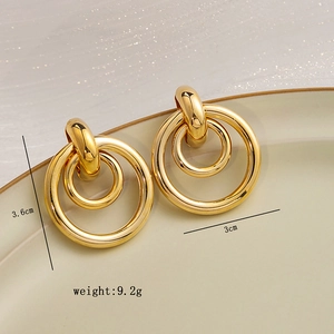 Detail view of gold double hoop earrings with dimensions 3.6cm by 3cm and 9.2g weight