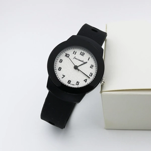 Detailed macro view of quartz watch with black silicone strap and white textured dial