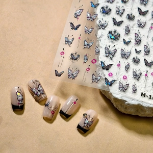 Dark butterfly nail art stickers with embossed holographic effect and pearl accents