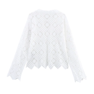 Detail of white hollow lace top showing intricate geometric patterns and scalloped hem