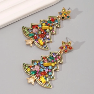Macro view of Christmas tree earrings with colorful rhinestones and gold star accents
