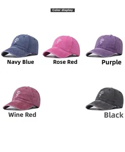 Detail view of five washed cotton baseball caps with embroidered white rose patterns