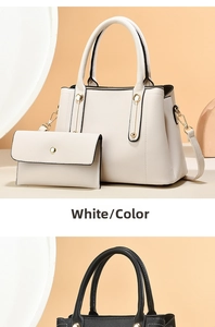 White pebbled leather handbag set with gold cylinder accents on a beige backdrop