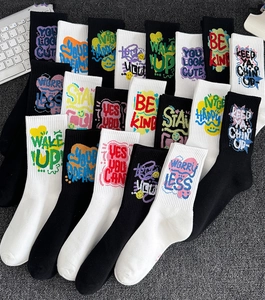 Detail of crew socks with colorful street graffiti prints in black and white styles