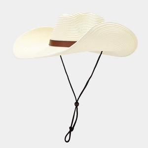 Close-up of beige straw sun hat with brown leather band and adjustable wind strap