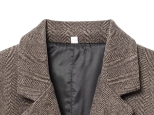 Detail shot of brown herringbone wool blazer collar and premium sewing texture