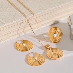 Detailed set of gold titanium steel jewelry featuring concentric circles and crystals