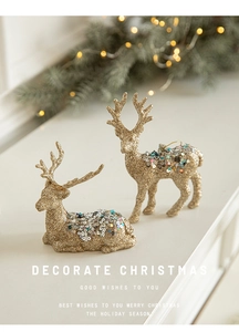 Exquisite golden reindeer figurines with sequins set on a festive warm mantelpiece