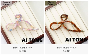 Detailed size view of large acetate bow hair claws in purple and amber patterns