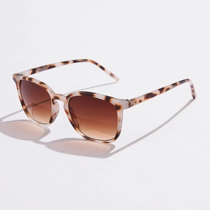 Detail of tortoise shell pattern frames with brown gradient lenses on square sunglasses