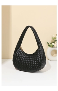 Close-up of the black leather woven texture and zipper on the stylish hobo bag