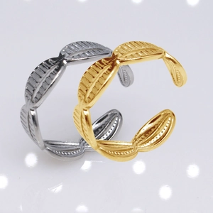 Detailed close-up of adjustable leaf-shaped open rings in gold and silver finishes