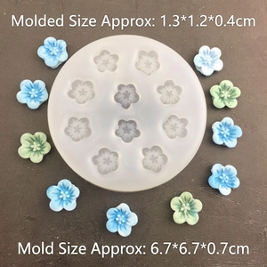 Detailed top view of 10-cavity cherry blossom silicone mold with finished floral resin pieces