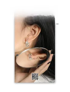 Close-up of S925 sterling silver multi-layered geometric hoop earrings on model