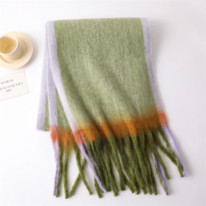 Detail of color-blocked gradient scarf showing soft texture and delicate fringe tassels