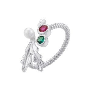 Detailed macro view of silver open ring with twisted band, pearls, gems, and metal leaves
