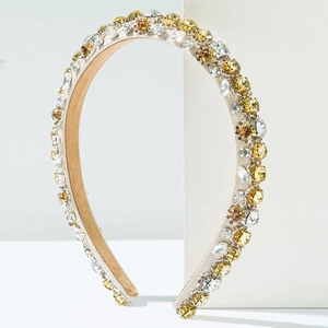 Detail of baroque rhinestone headband with yellow crystals and champagne fabric base
