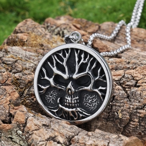 Collana gotica albero della vita con teschio in acciaio su sfondo naturale di muschio e corteccia