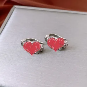 Macro shot of silver horseshoe ear cuff with pave cubic zirconia on grey jewelry box