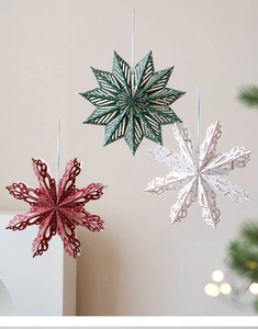 Three-dimensional paper Christmas ornaments in forest green, red and cream white colors