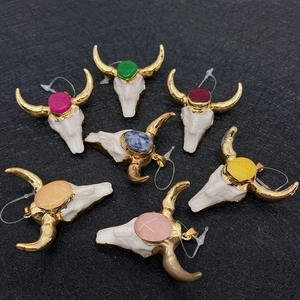 Group of colorful bull skull pendants with gold horns and varied gemstone centers