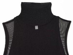 Detail of black sleeveless dress with mesh stitching and mock neck silver decoration