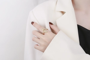 Detailed close-up of a gold-plated twisted ring featuring sparkling zircon star accents