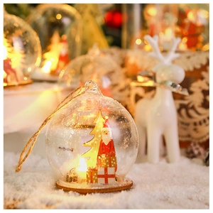 Macro view of Christmas glass globe with Santa and tree on wooden base with LED lights