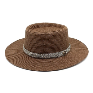 Detail of brown boater hat featuring fine woven texture and sparkling rhinestone band