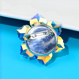 Detailed back view of flower brooch with silver metal base and safety pin fastener