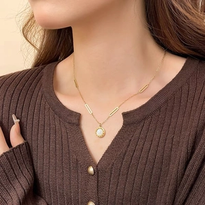 Minimalist stainless steel necklace with double-sided round pendant and Roman numerals