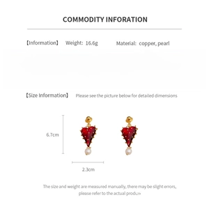 Detailed view of red heart earrings with pearls showing size dimensions and weight