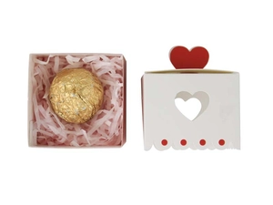 Pink heart-shaped cutout gift box set with chocolate and paper filler detail