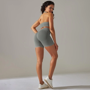 Detail of seamless knitted racerback sports bra and high-waisted shorts in sage green