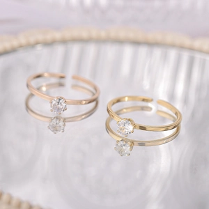 Macro view of adjustable gold-plated stainless steel rings with clear round crystals