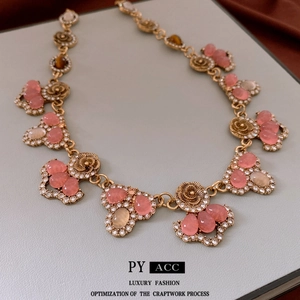 Vintage gold necklace with pink tiger eye gemstone and diamonds in flower teardrop design